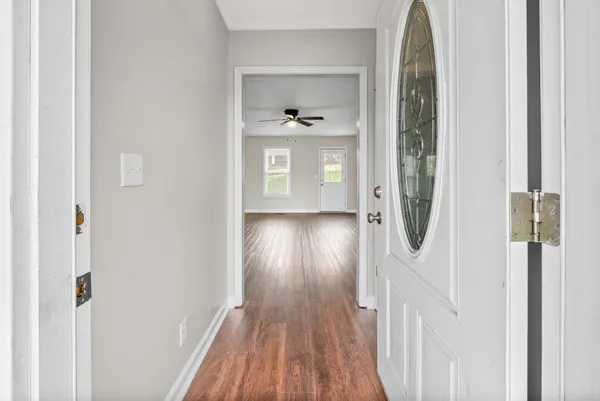 a view of hallway with wooden floor