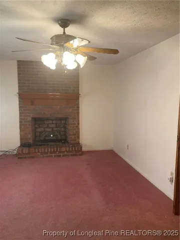 a view of empty room with window and fireplace
