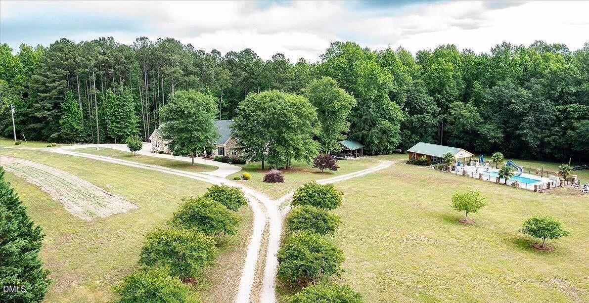 413 Johnson Town Road Zebulon, NC 27597 - Photo 7 of 42 a swimming pool with trees in the background