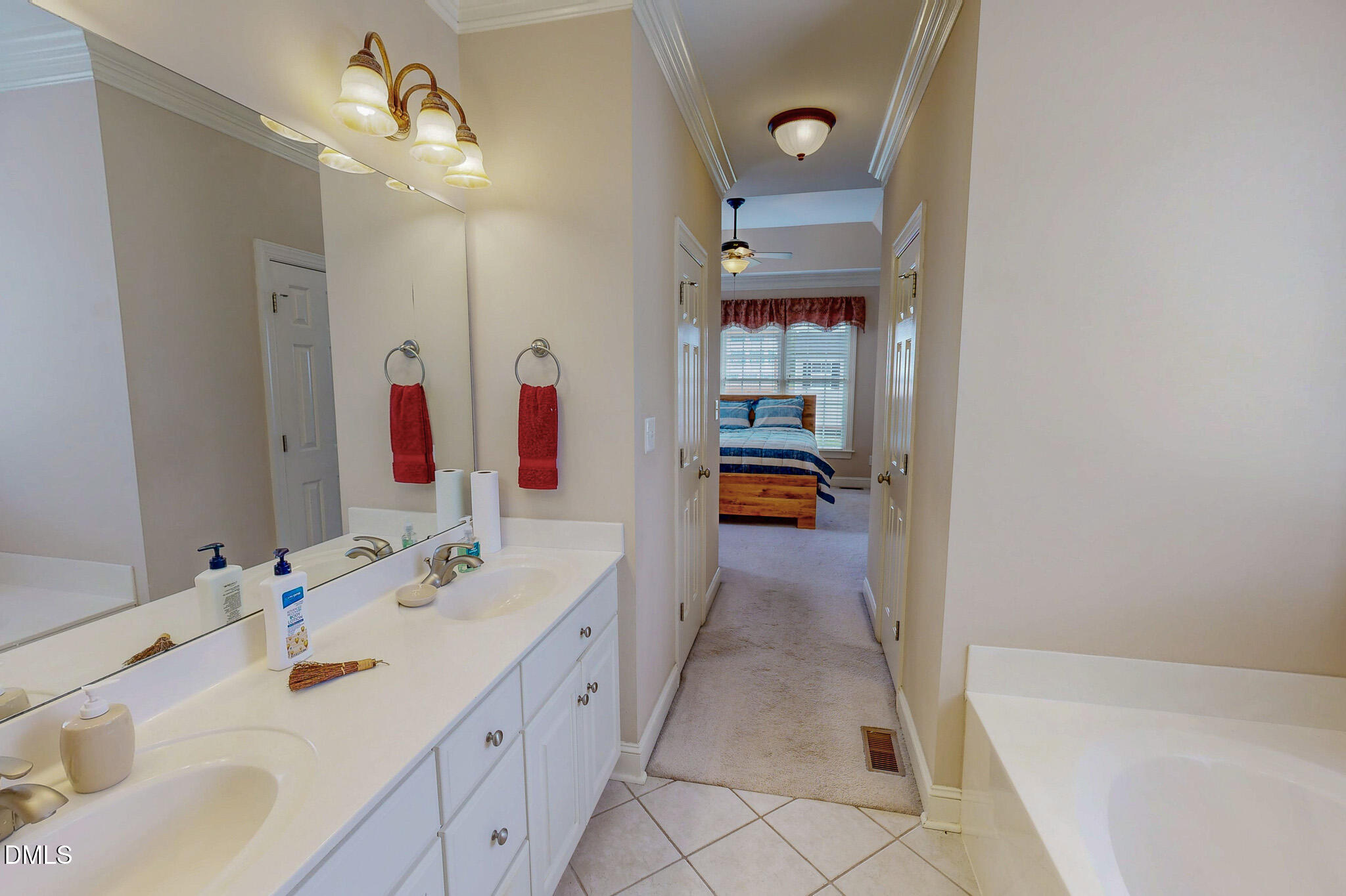 115 Duncan Plantation Road Timberlake, NC 27583 - Photo 18 of 48 a bathroom with a tub sink and mirror