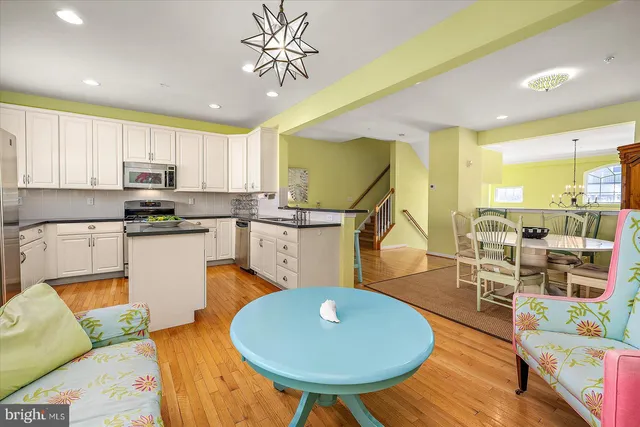 a view of a dining room with furniture a chandelier and wooden floor