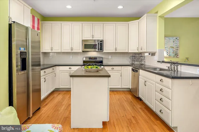 a bedroom with a bed chandelier and a window