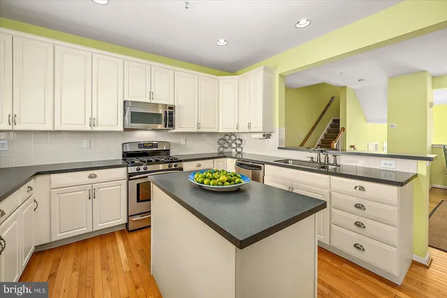 a spacious bedroom with a bed and a mirror