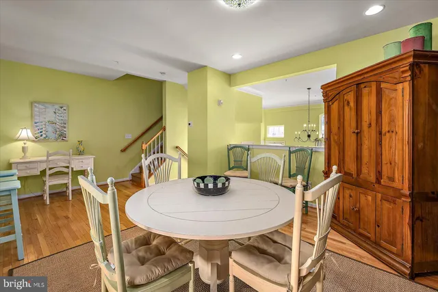 a view of a bedroom with wooden floor and windows