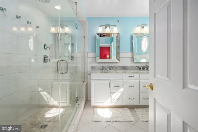 a living room with furniture large windows and wooden floor