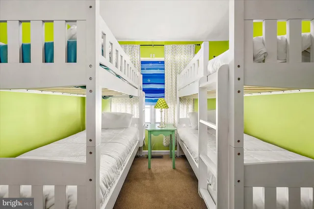 a front view of a house with a yard and lake view