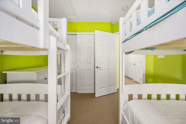 a view of a lake from a balcony with outdoor seating