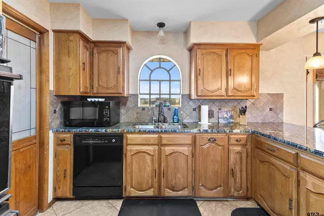 a living room with furniture a fireplace and a chandelier
