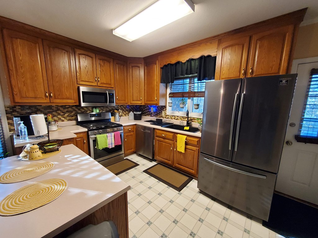 3459 Lickskillet Road Epworth, GA 30541 - Photo 6 of 26 a kitchen with granite countertop stainless steel appliances and wooden cabinets