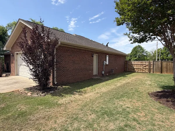 a front view of house with yard and trees