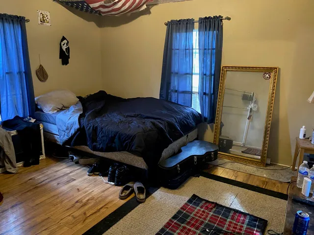 a bedroom with a bed and a mirror