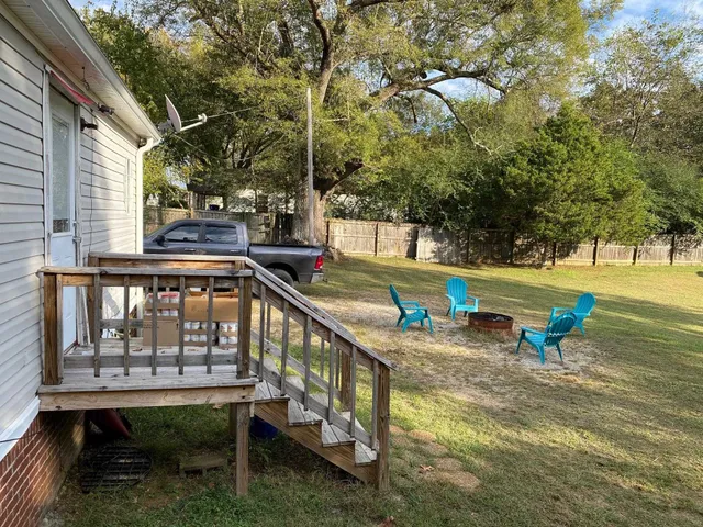 a view of a lake with a bench and trees around