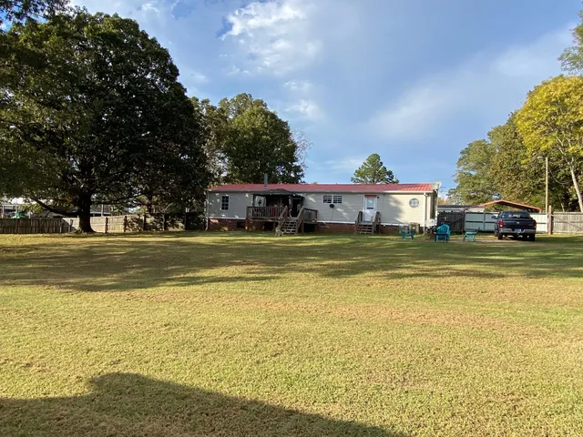 a view of swimming pool with outdoor seating and yard