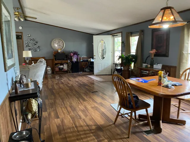 a living room with furniture and a mirror