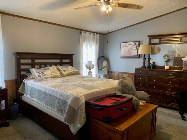 a bed room with a bed and a dresser