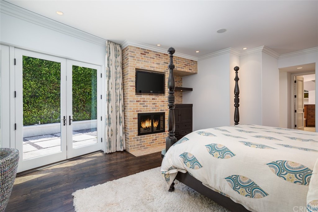 841 Emerald Bay Laguna Beach, CA 92651 - Photo 15 of 31 a spacious bedroom with a bed and a fireplace