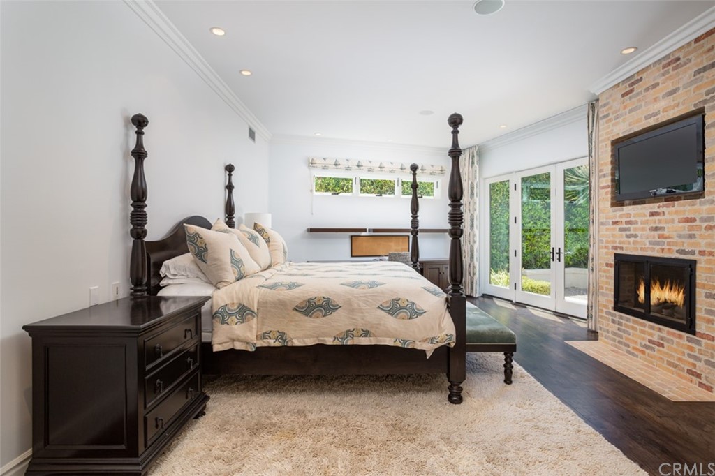 841 Emerald Bay Laguna Beach, CA 92651 - Photo 16 of 31 a bed room with a bed and a fireplace