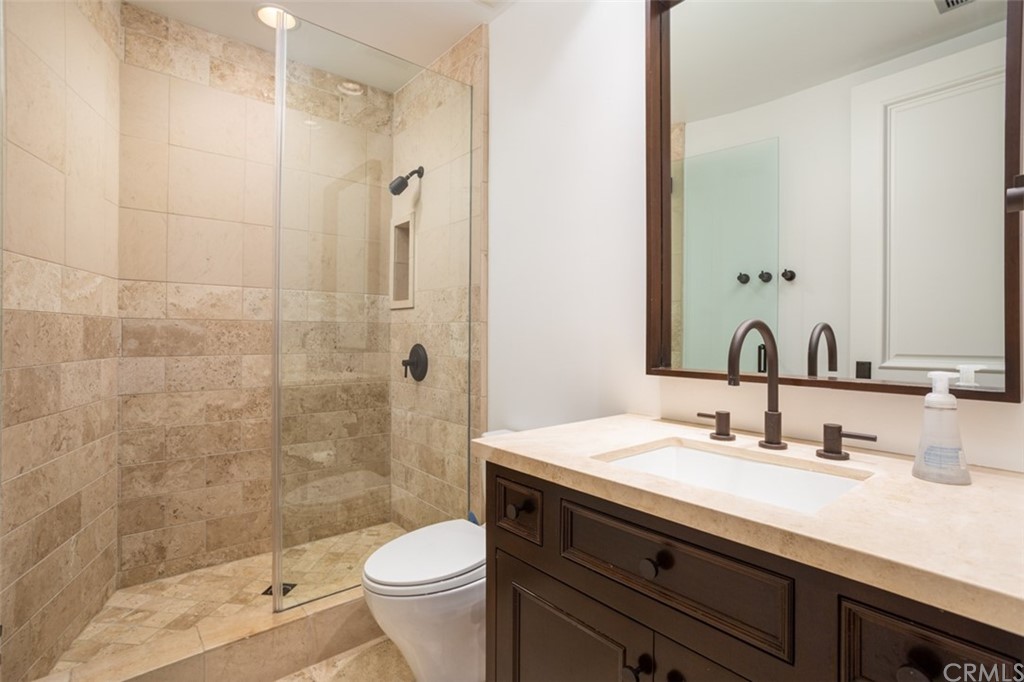 841 Emerald Bay Laguna Beach, CA 92651 - Photo 26 of 31 a bathroom with a sink and a mirror