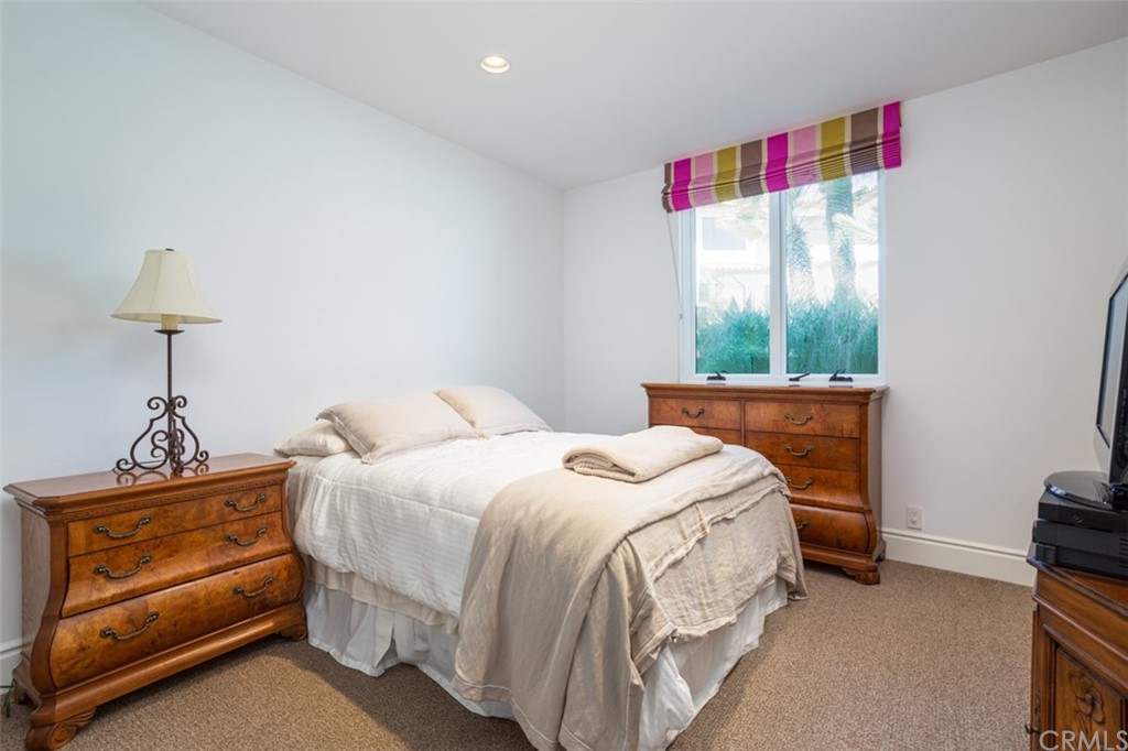 841 Emerald Bay Laguna Beach, CA 92651 - Photo 27 of 31 a bedroom with a bed and a window