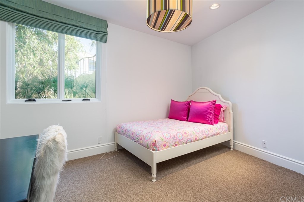 841 Emerald Bay Laguna Beach, CA 92651 - Photo 29 of 31 a bedroom with a bed and a window