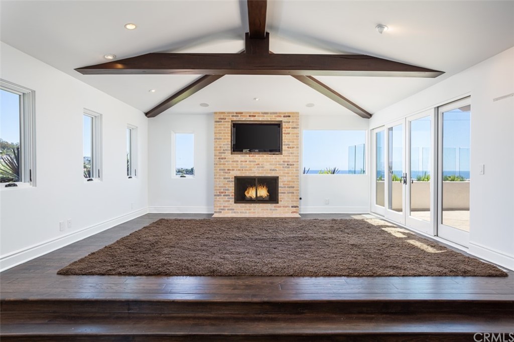 841 Emerald Bay Laguna Beach, CA 92651 - Photo 4 of 31 a living room with granite countertop hardwood floor pool table and a fireplace