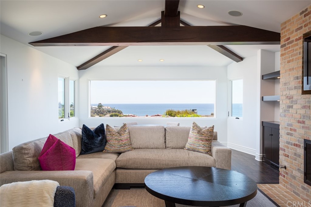 841 Emerald Bay Laguna Beach, CA 92651 - Photo 8 of 31 a living room with furniture and a fireplace