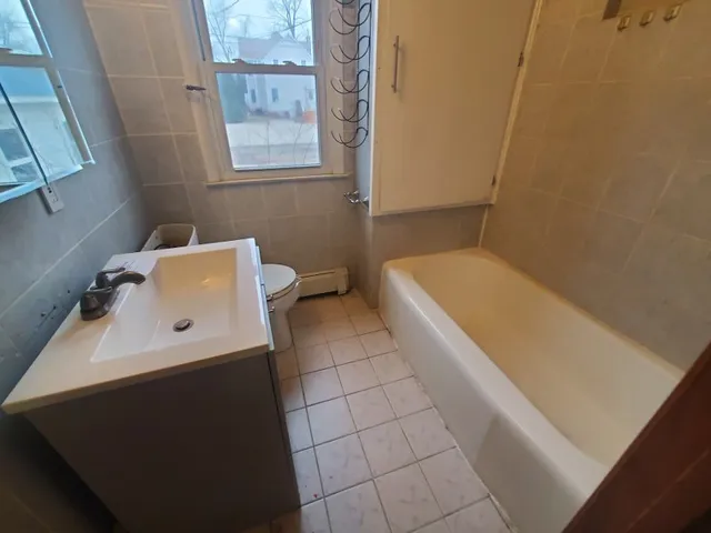 an empty room with a mirror and a window