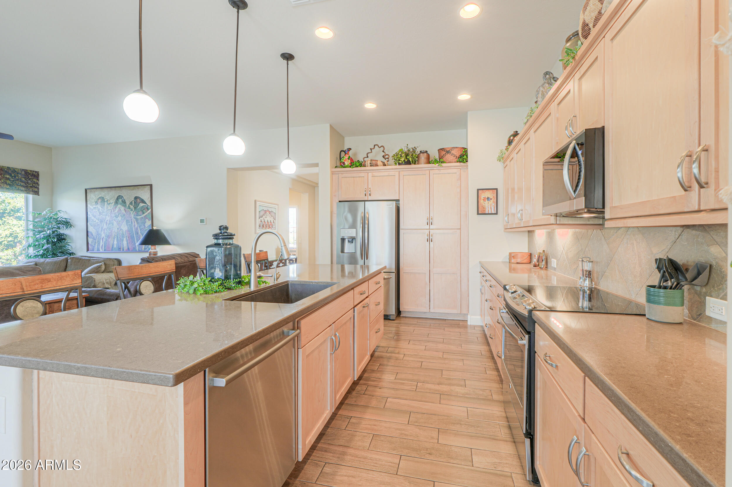 5048 North Scottsdale Road Eloy, AZ 85131 - Photo 11 of 53 a kitchen with stainless steel appliances granite countertop a sink a stove and a refrigerator