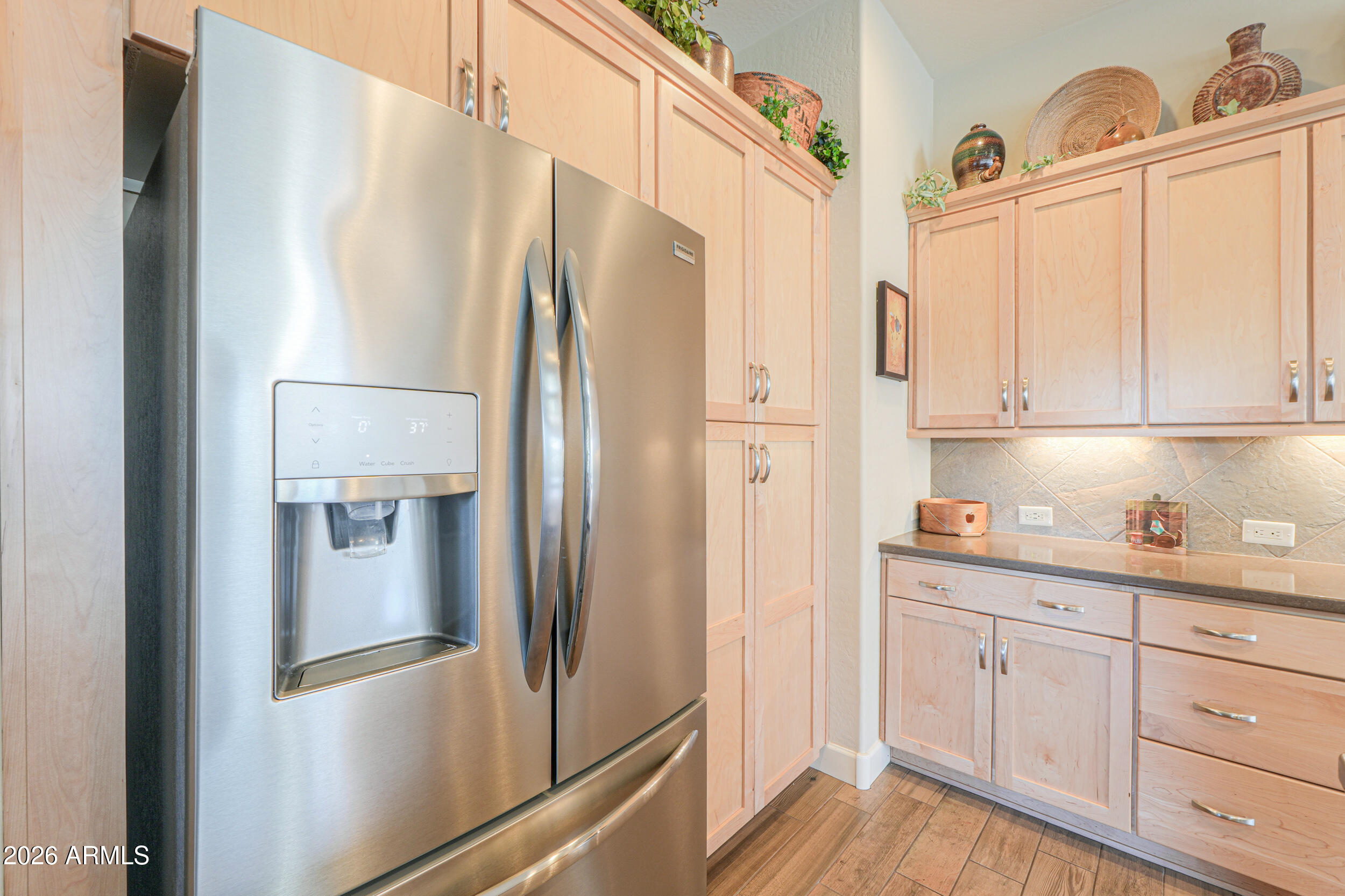 5048 North Scottsdale Road Eloy, AZ 85131 - Photo 13 of 53 a metallic refrigerator freezer sitting in a kitchen