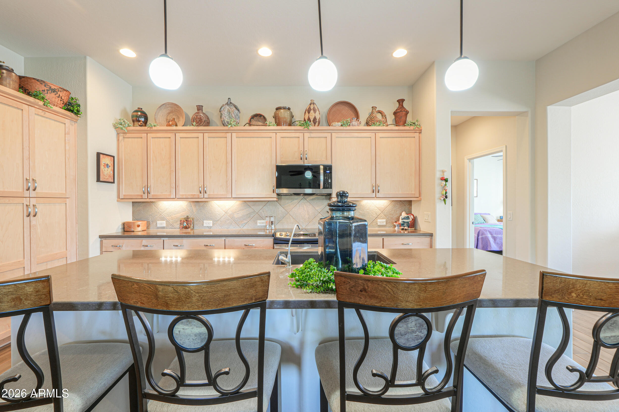 5048 North Scottsdale Road Eloy, AZ 85131 - Photo 10 of 53 a kitchen with stainless steel appliances granite countertop a stove a refrigerator and a dining table with chairs