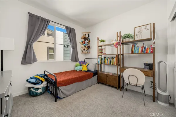 a bedroom with furniture and a window