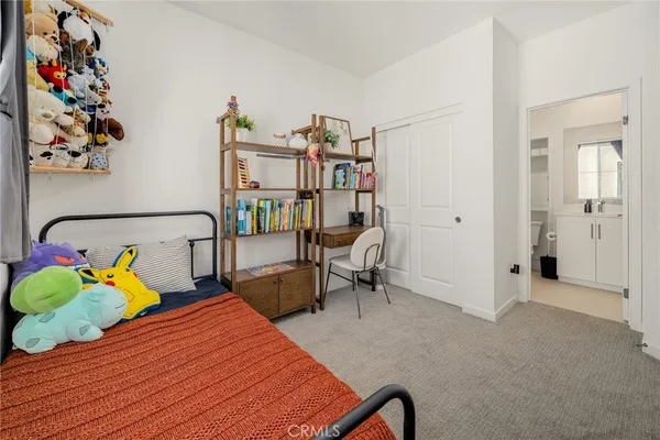 a bedroom with furniture and a chair