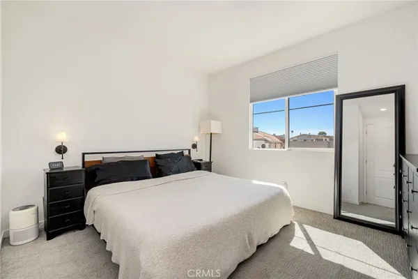 a bedroom with a bed and a lamp with window