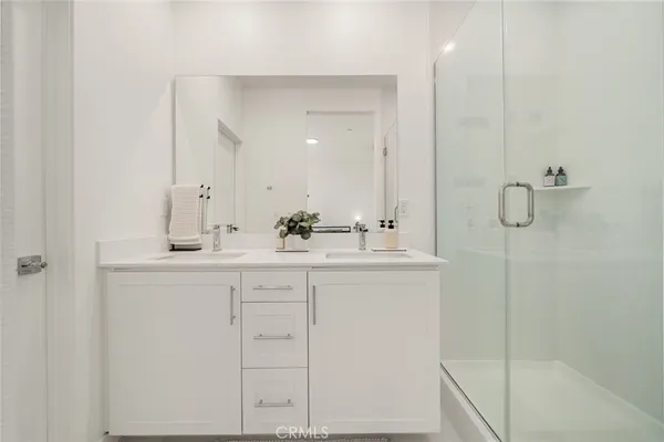 a bathroom with a shower sink and mirror