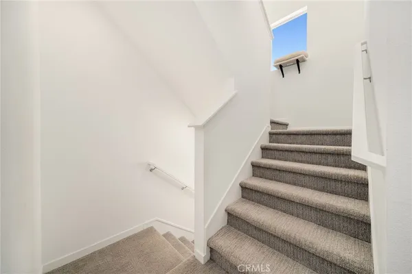 a view of staircase with white walls