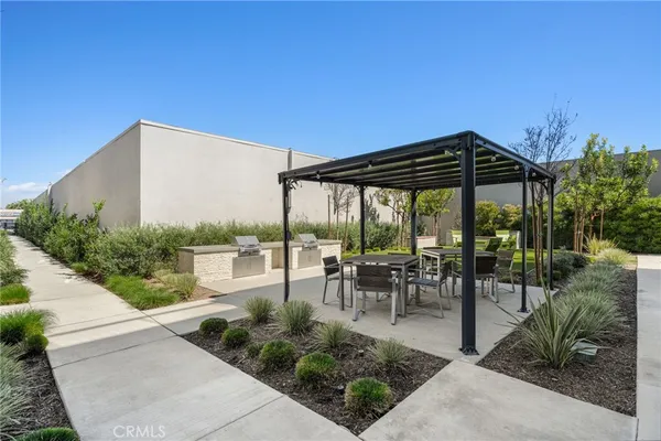 a view of a tables and chairs under an umbrella in patio