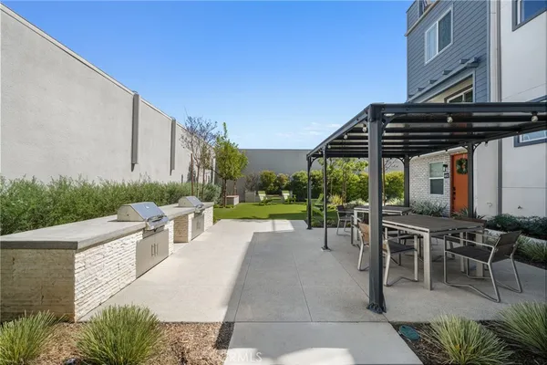 a view of a patio with a table and chairs