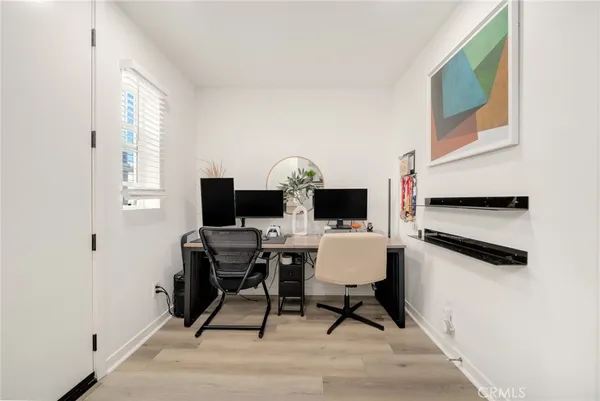 a view of a workspace with furniture and a window