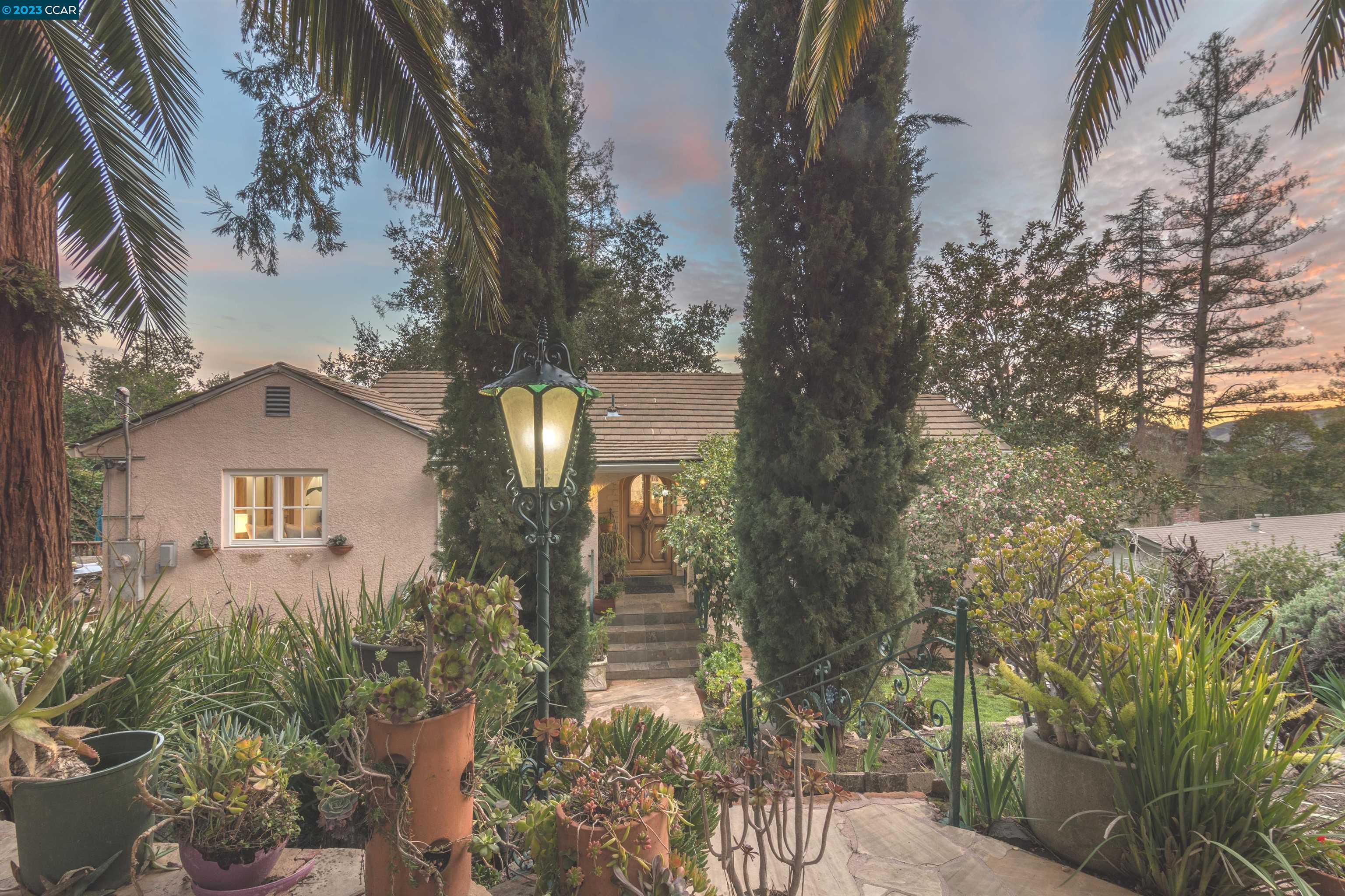 a front view of a house with trees