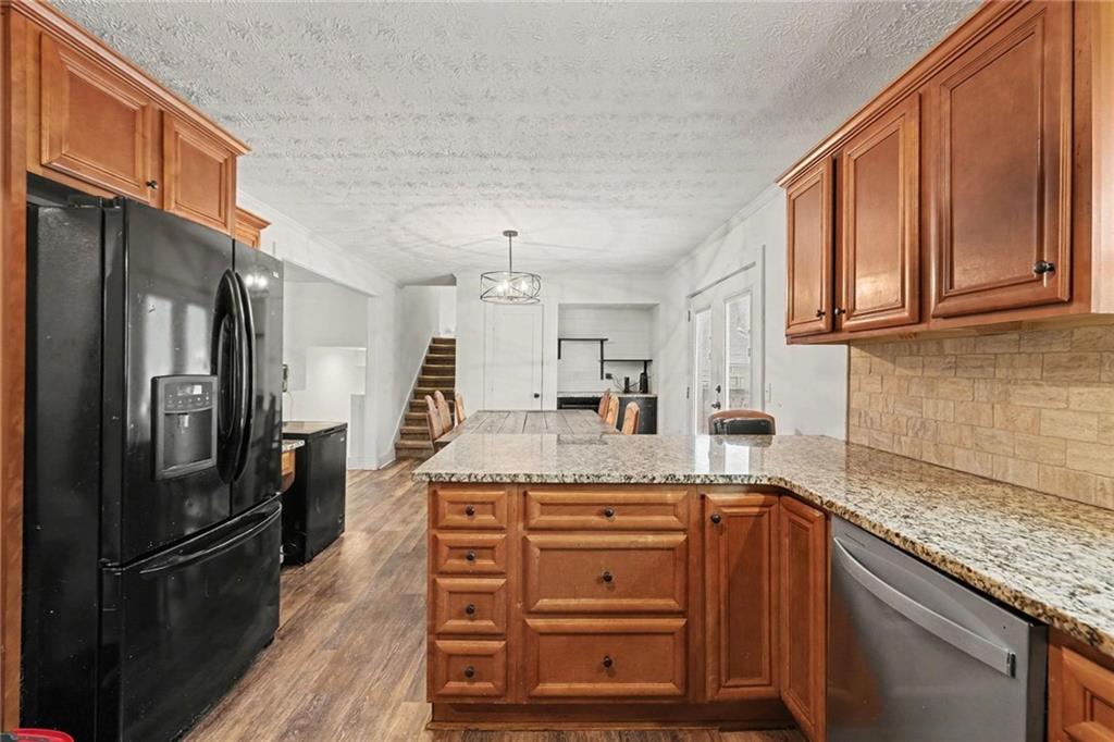 221 Rome Street Temple, GA 30179 - Photo 17 of 30 a kitchen with stainless steel appliances granite countertop a refrigerator sink and cabinets