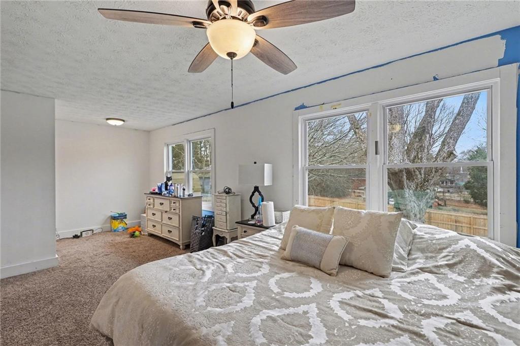 221 Rome Street Temple, GA 30179 - Photo 19 of 30 a bedroom with a bed and a large window