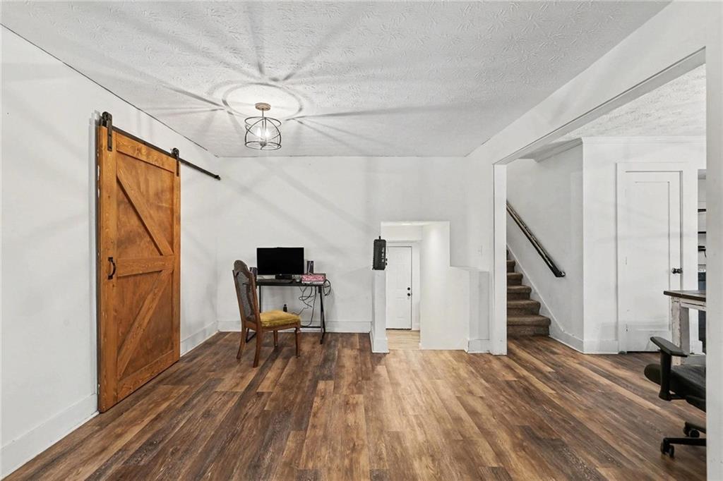 221 Rome Street Temple, GA 30179 - Photo 5 of 30 a view of a livingroom with wooden floor and staircase