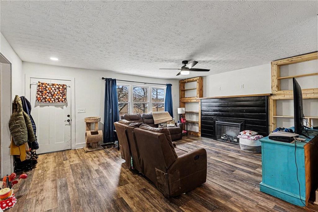 221 Rome Street Temple, GA 30179 - Photo 8 of 30 a living room with furniture a fireplace and a flat screen tv