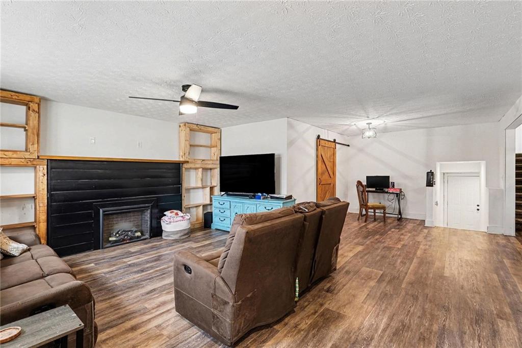 221 Rome Street Temple, GA 30179 - Photo 10 of 30 a living room with furniture a fireplace and a flat screen tv