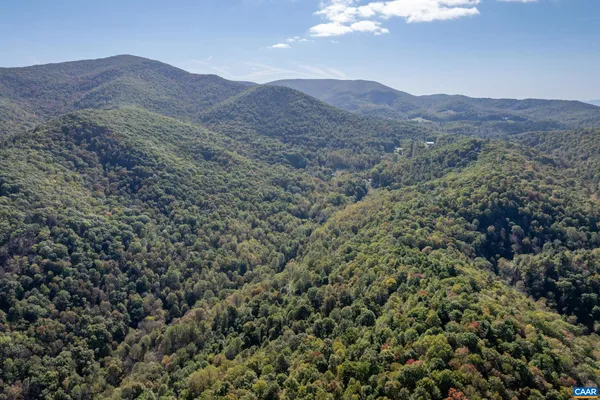 a view of a mountain range in a cloudy sky