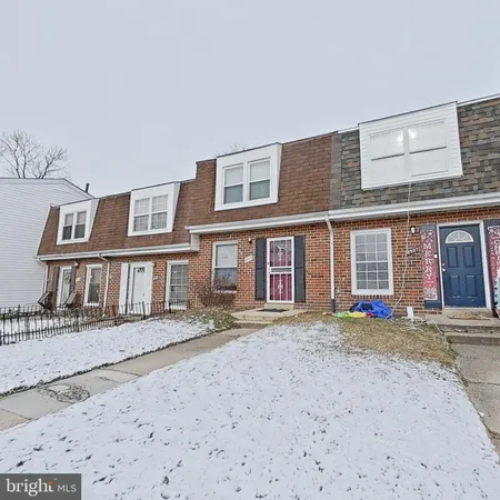 a front view of a brick house with a yard