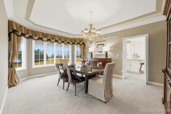 a view of a dining room with furniture and a chandelier