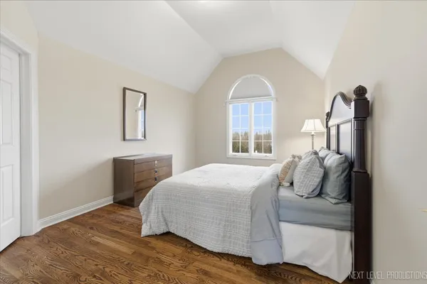 a bedroom with a bed and a chair