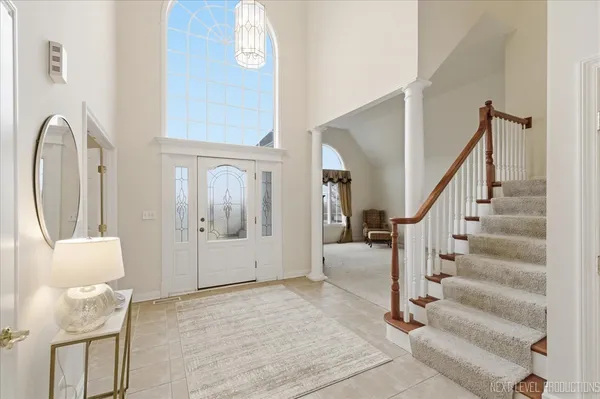a view of hall way with furniture and a mirror