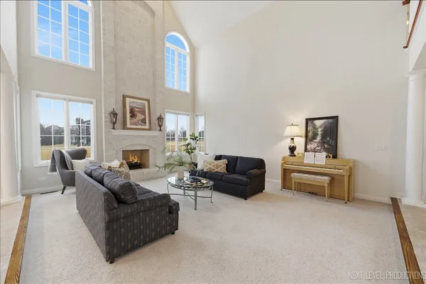 a living room with furniture and a fireplace